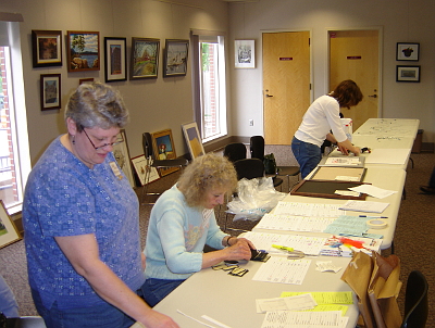 Joan Shackford, Angela Orsene and Ann Hearn receiving the artworks